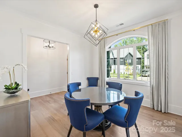 a dining room with furniture a window and a chandelier