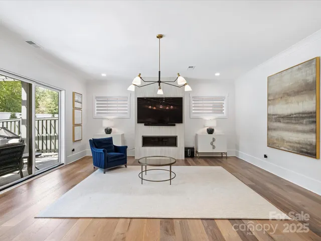 a living room with furniture a window and a chandelier
