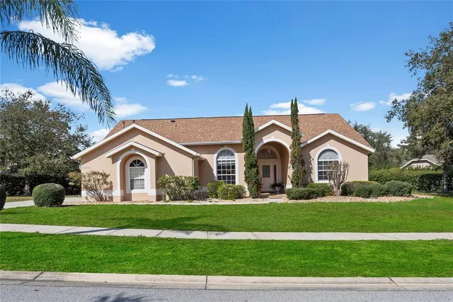 a front view of a house with a garden and yard