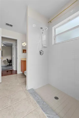 a view of a bathroom with a shower and a sink