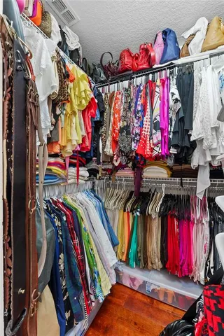 a view of walk in closet with clothes