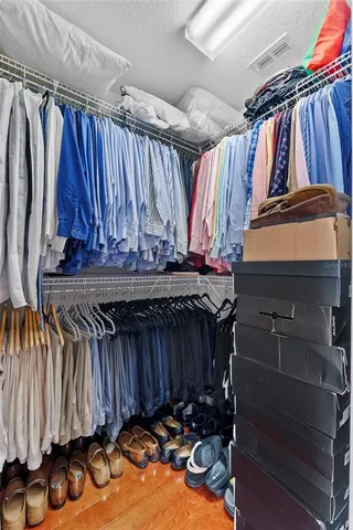 a view of walk in closet with clothes
