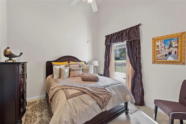 a bedroom with a bed and a painting on the wall