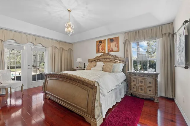 a bedroom with a bed window and a flat screen tv