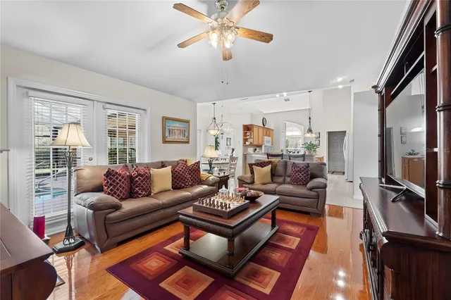 a dining room with furniture wooden floor and a chandelier