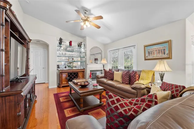 a kitchen with a sink and a potted plant with wooden floor