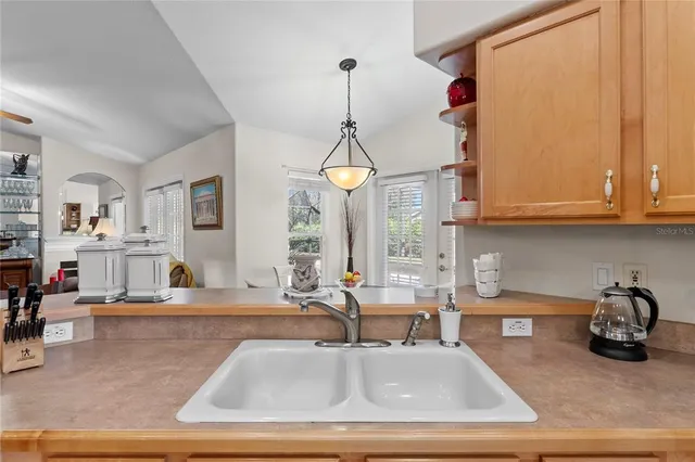 a kitchen that has a lot of cabinets in it and a refrigerator