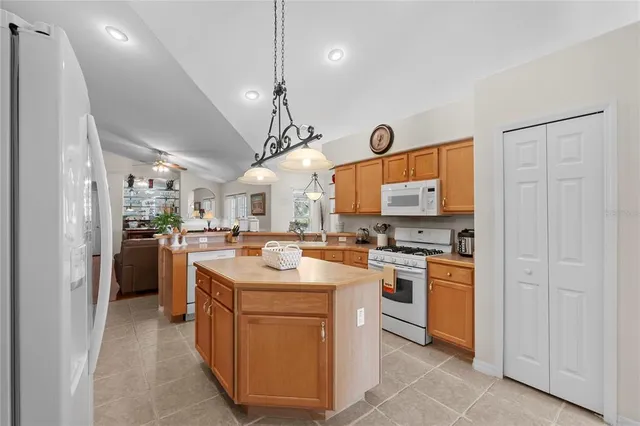 a kitchen with granite countertop a sink stainless steel appliances and cabinets