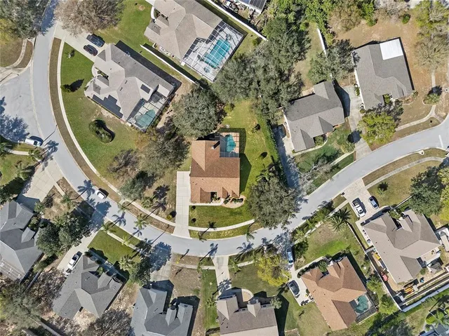 an aerial view of residential houses with outdoor space
