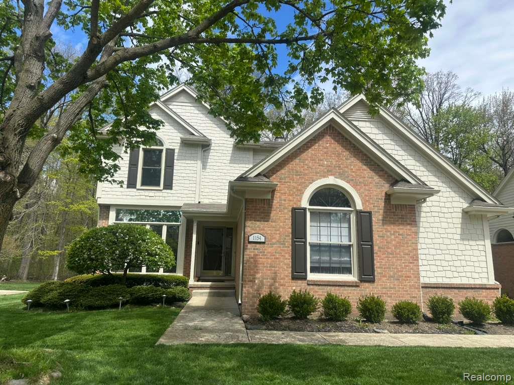 1154 Bluebird Drive Rochester, MI 48307 - Photo 1 of 34 Brick and shingle-sided exterior with arched window detail