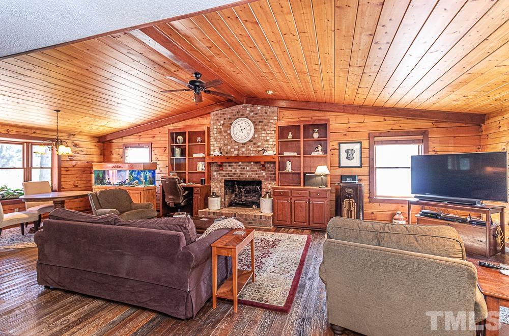 1409 Frazier Road Spring Hope, NC 27882 - Photo 2 of 28 a living room with fireplace furniture and a large window