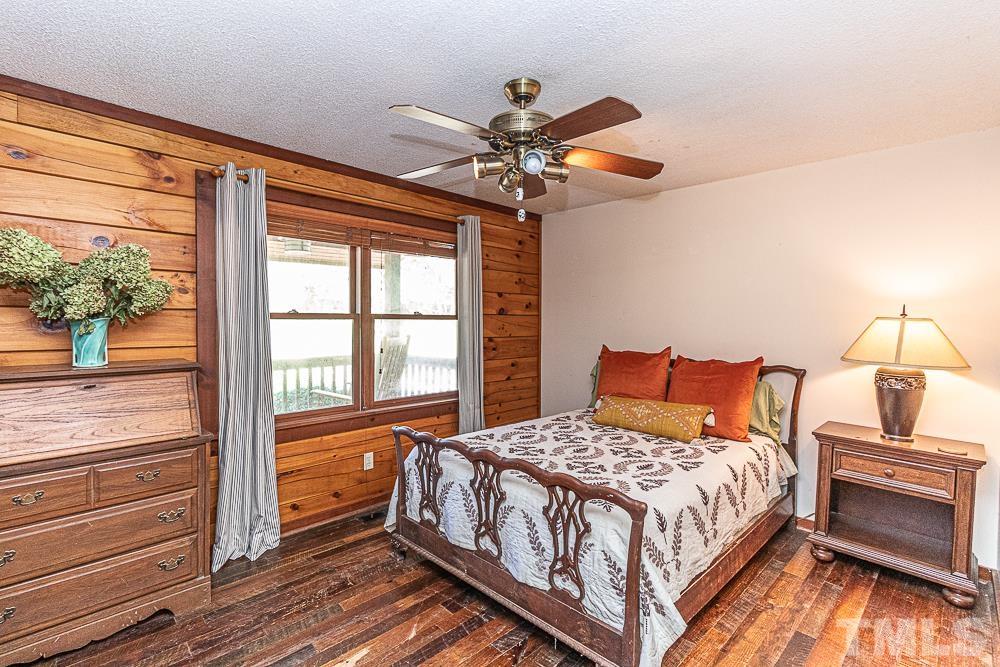 1409 Frazier Road Spring Hope, NC 27882 - Photo 12 of 28 a bedroom with a bed and wooden floor