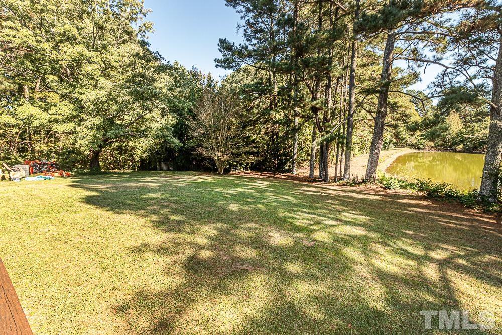1409 Frazier Road Spring Hope, NC 27882 - Photo 23 of 28 a view of yard with swimming pool and trees