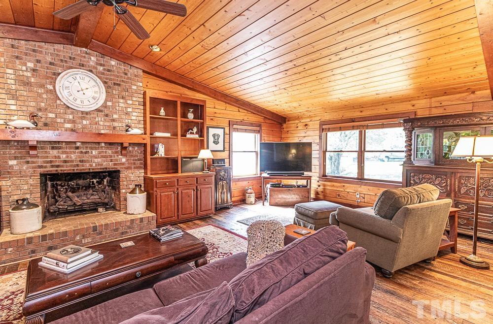 1409 Frazier Road Spring Hope, NC 27882 - Photo 4 of 28 a living room with furniture a fireplace and a large window