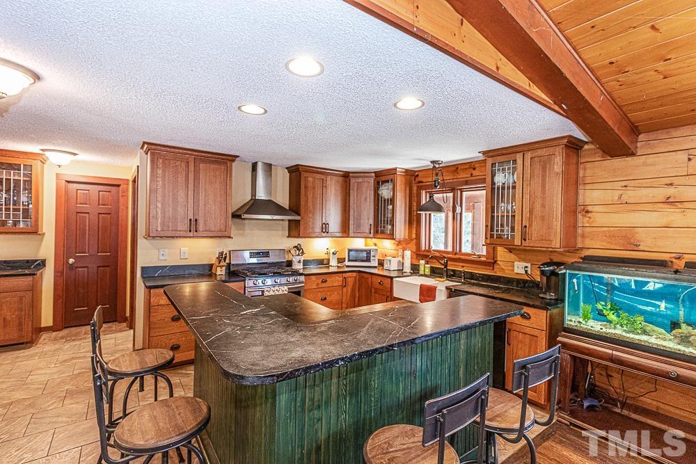 1409 Frazier Road Spring Hope, NC 27882 - Photo 6 of 28 a kitchen with granite countertop lots of counter top space and stainless steel appliances