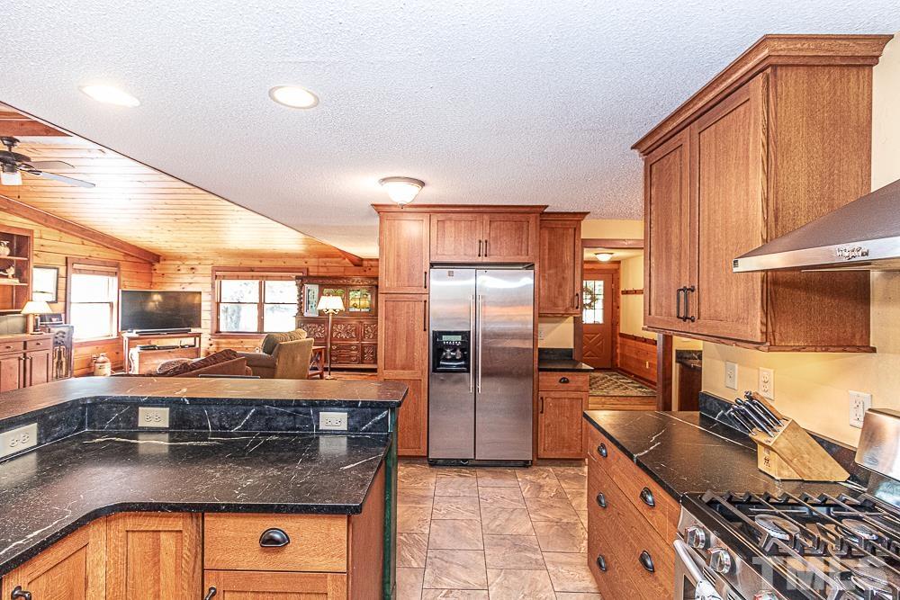 1409 Frazier Road Spring Hope, NC 27882 - Photo 8 of 28 a kitchen with stainless steel appliances granite countertop a sink stove and refrigerator
