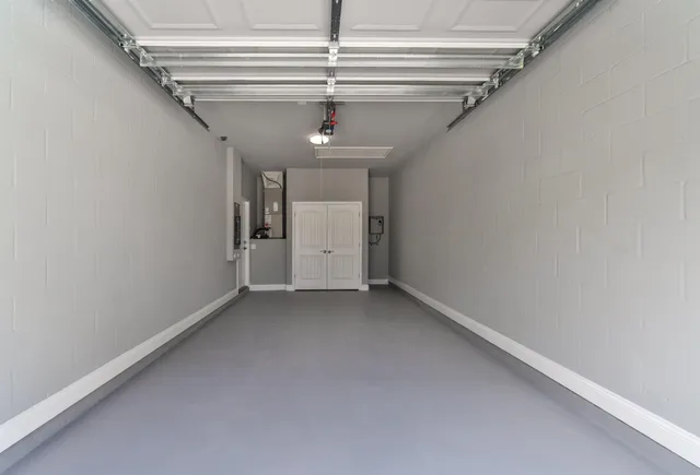 a bathroom with a granite countertop toilet sink and mirror