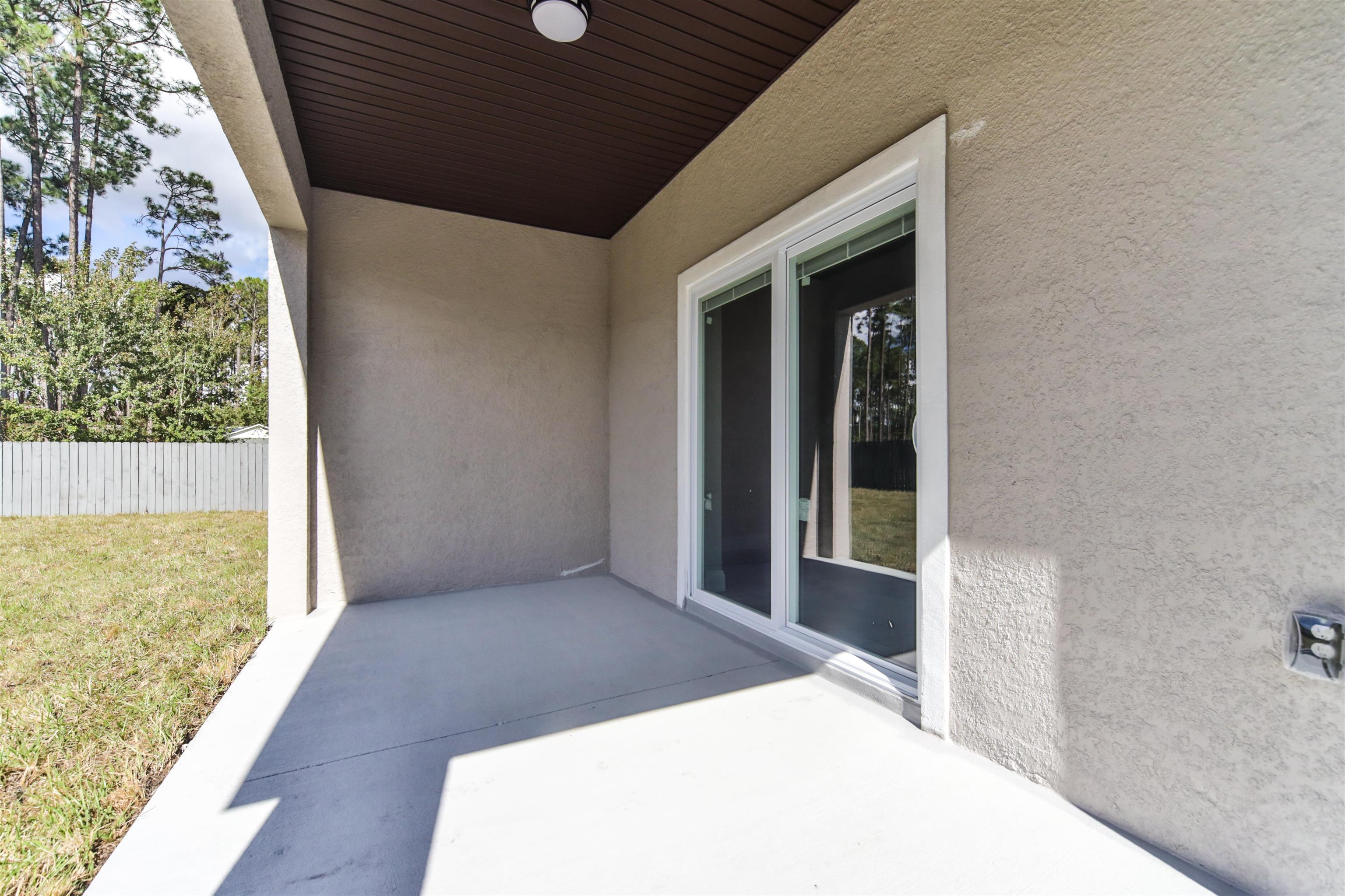 9 Seton Place Palm Coast, FL 32164 - Photo 31 of 37 a view of an empty room with wooden floor and a window