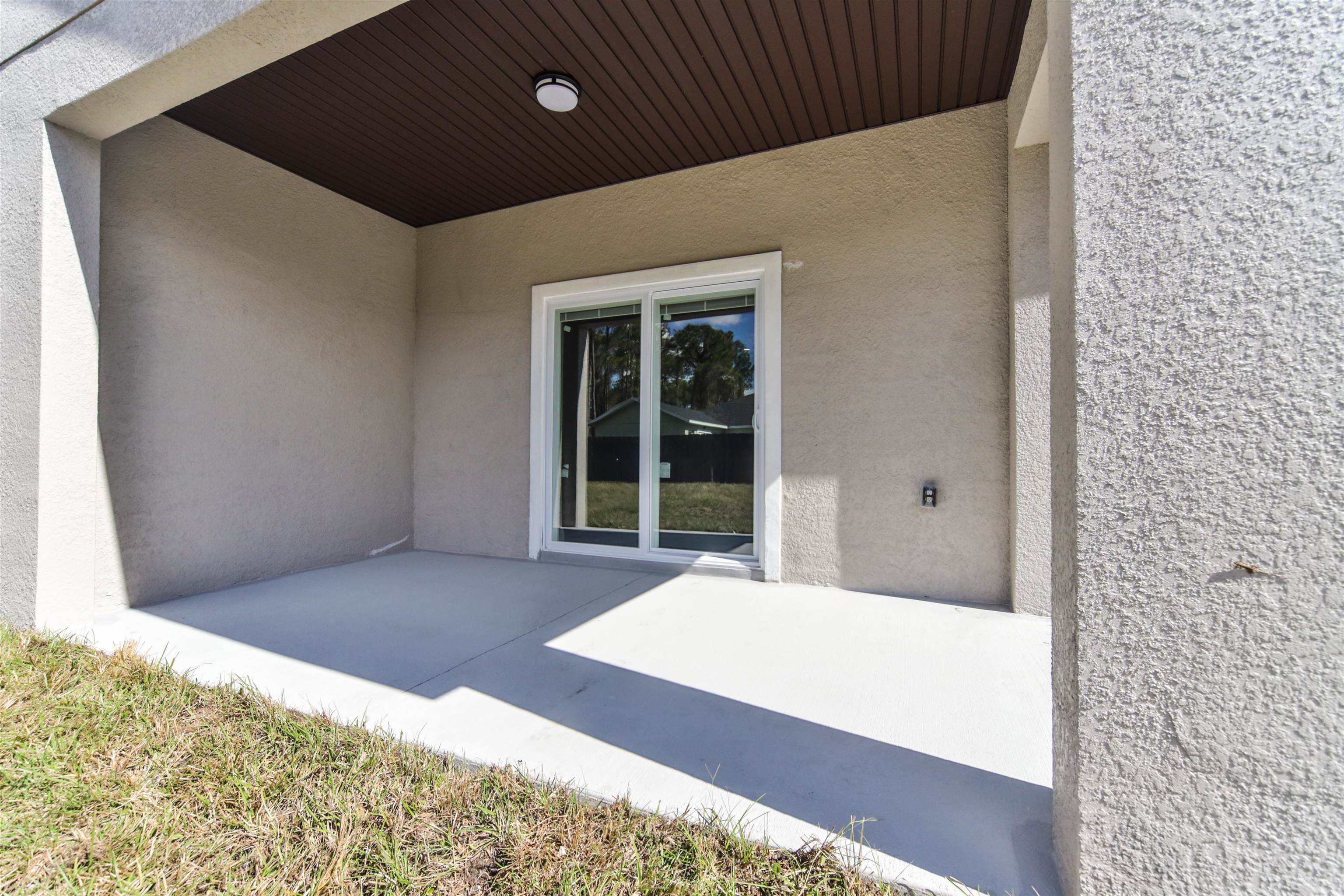 9 Seton Place Palm Coast, FL 32164 - Photo 32 of 37 a bedroom with a bed and a large window