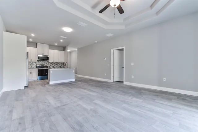 a view of a kitchen with a sink and stainless steel appliances