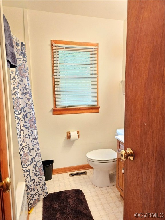 446 Hideaway Point Road Topping, VA 23169 - Photo 16 of 22 a bathroom with a toilet and a shower curtain