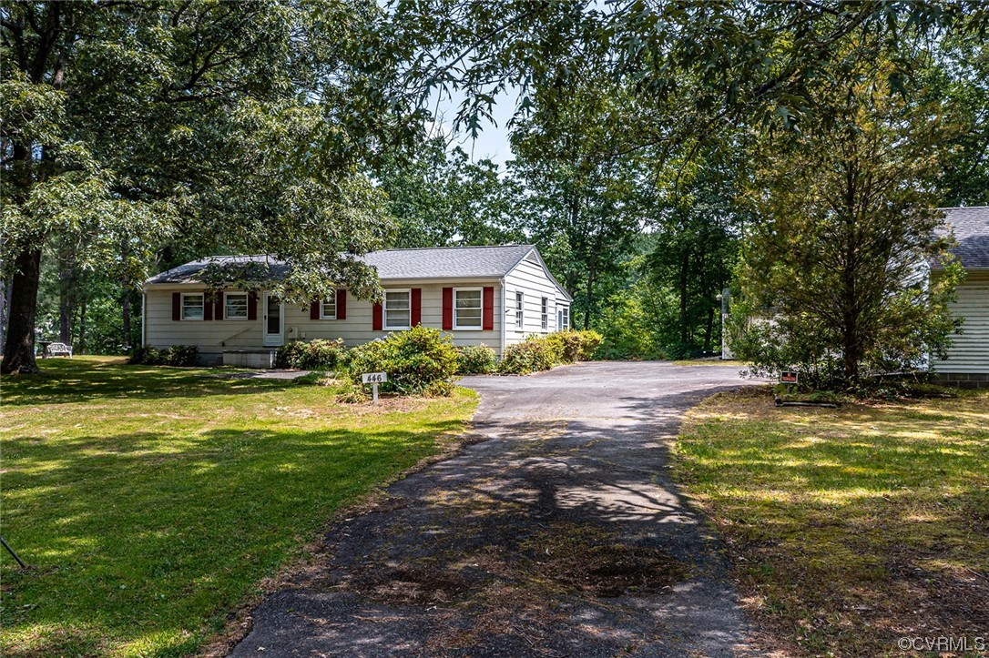 446 Hideaway Point Road Topping, VA 23169 - Photo 2 of 22 a front view of a house with swimming pool