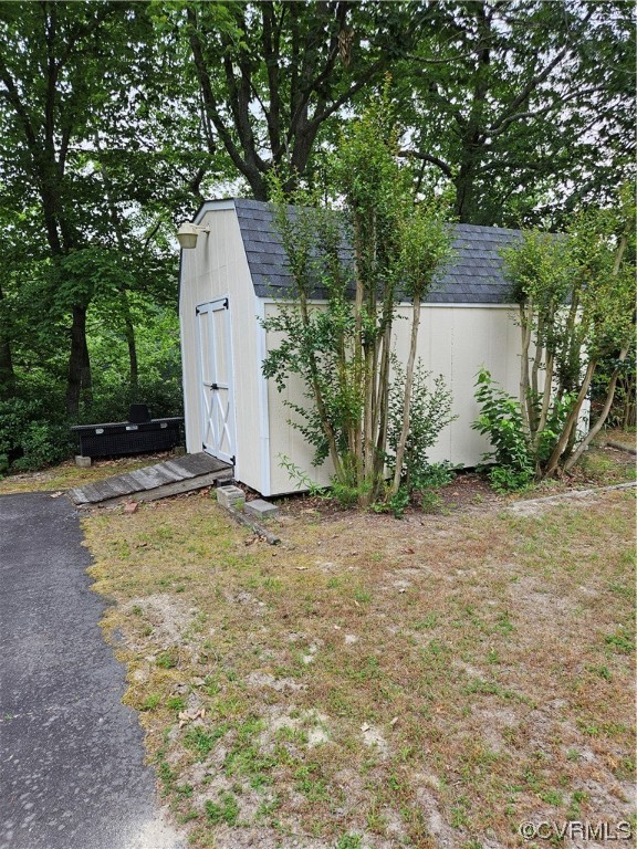 446 Hideaway Point Road Topping, VA 23169 - Photo 22 of 22 a backyard of a house with a yard and garage