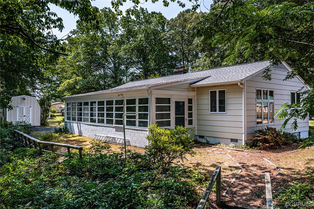 446 Hideaway Point Road Topping, VA 23169 - Photo 9 of 22 a house with lots of trees in the background
