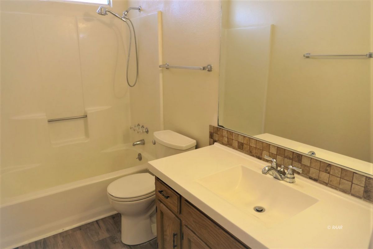 933 West Perdew Avenue Ridgecrest, CA 93555 - Photo 17 of 21 a bathroom with a sink a toilet and shower