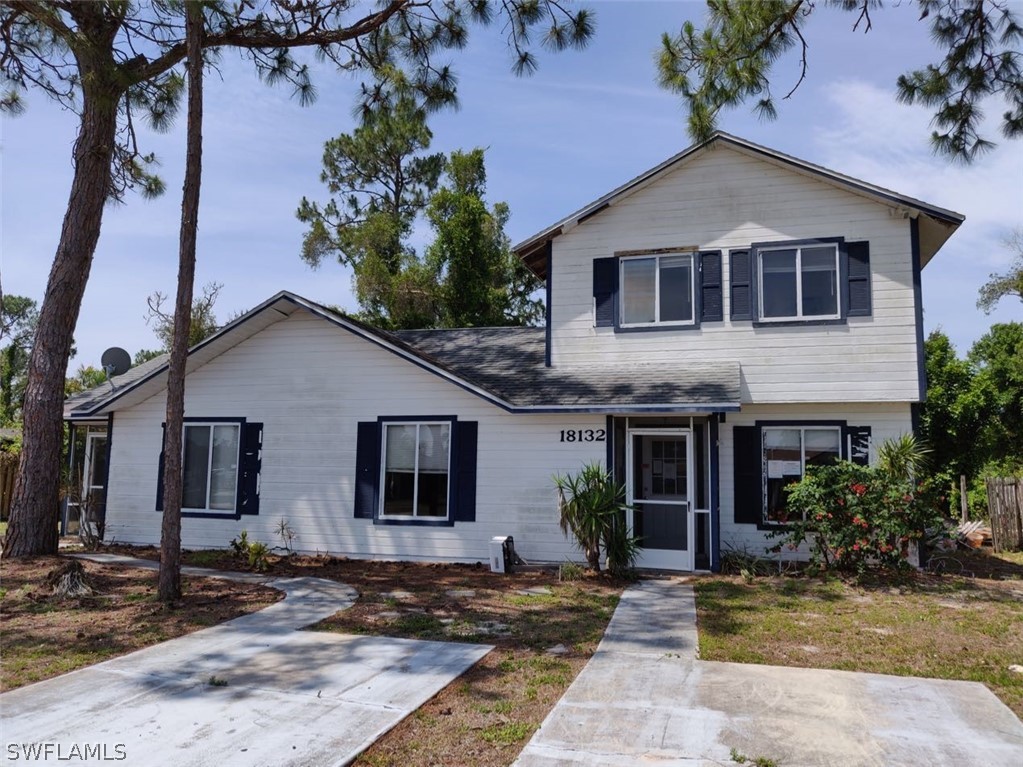 18132 Matanzas Road Fort Myers, FL 33967 - Photo 1 of 22 a front view of a house with garden