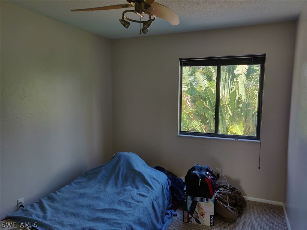 18132 Matanzas Road Fort Myers, FL 33967 - Photo 14 of 22 a bedroom with a bed and a window