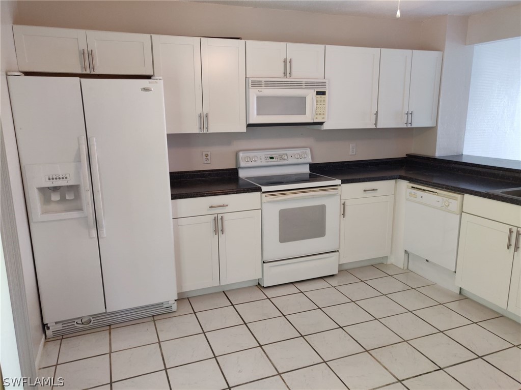 18132 Matanzas Road Fort Myers, FL 33967 - Photo 16 of 22 a kitchen with white cabinets and white appliances