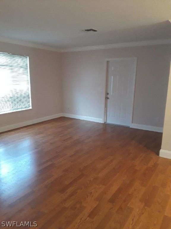 18132 Matanzas Road Fort Myers, FL 33967 - Photo 3 of 22 an empty room with wooden floor and windows