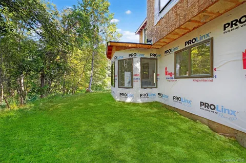 a front view of house with yard and green space