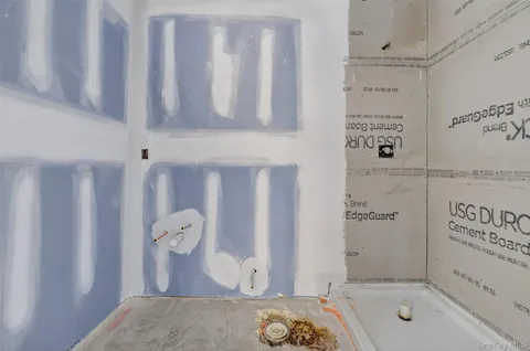 a bathroom with a tub sink and shower curtain