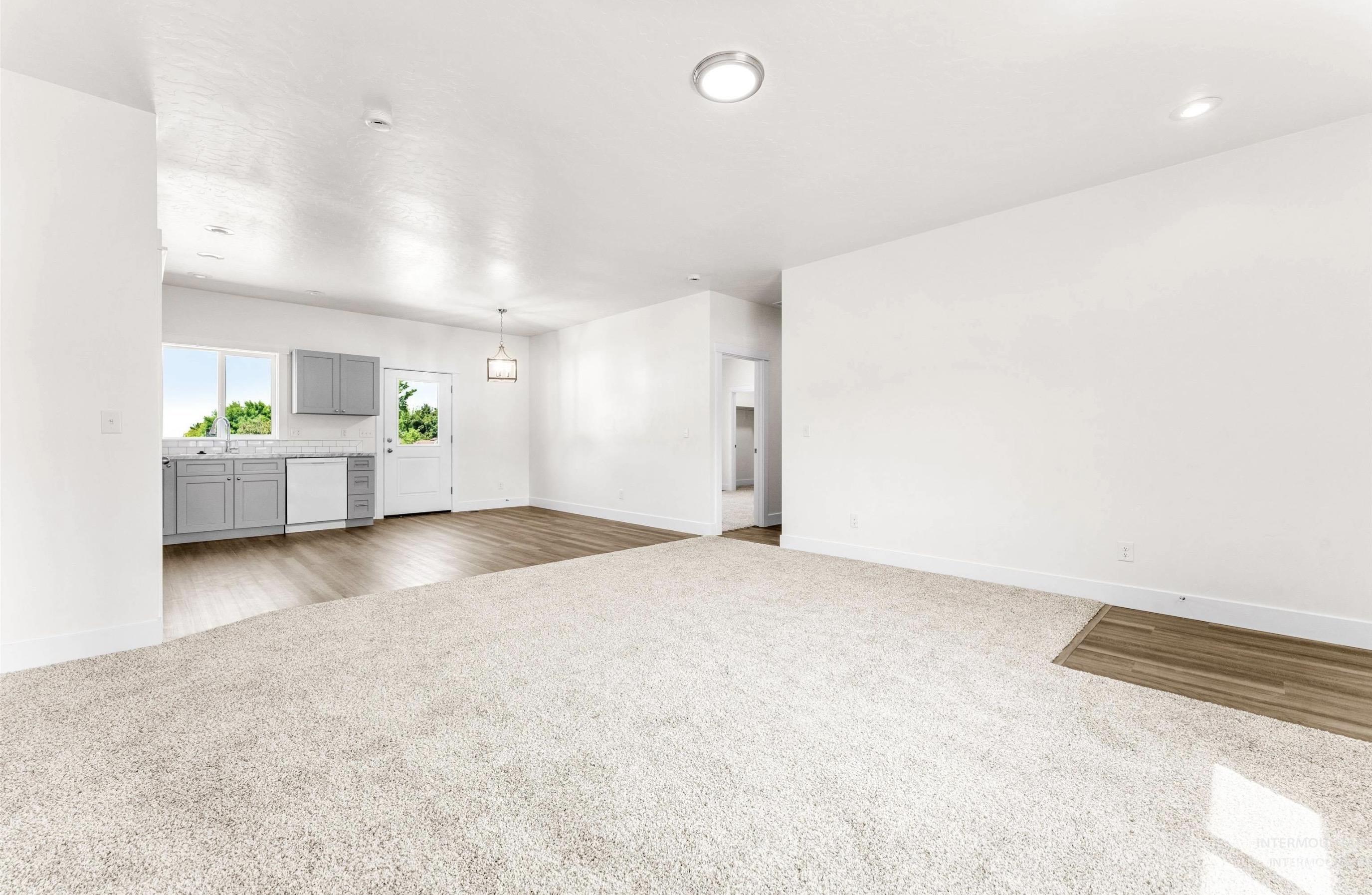 1771 Regency Way Emmett, ID 83617 - Photo 3 of 9 Unfurnished living room with carpet floors and baseboards
