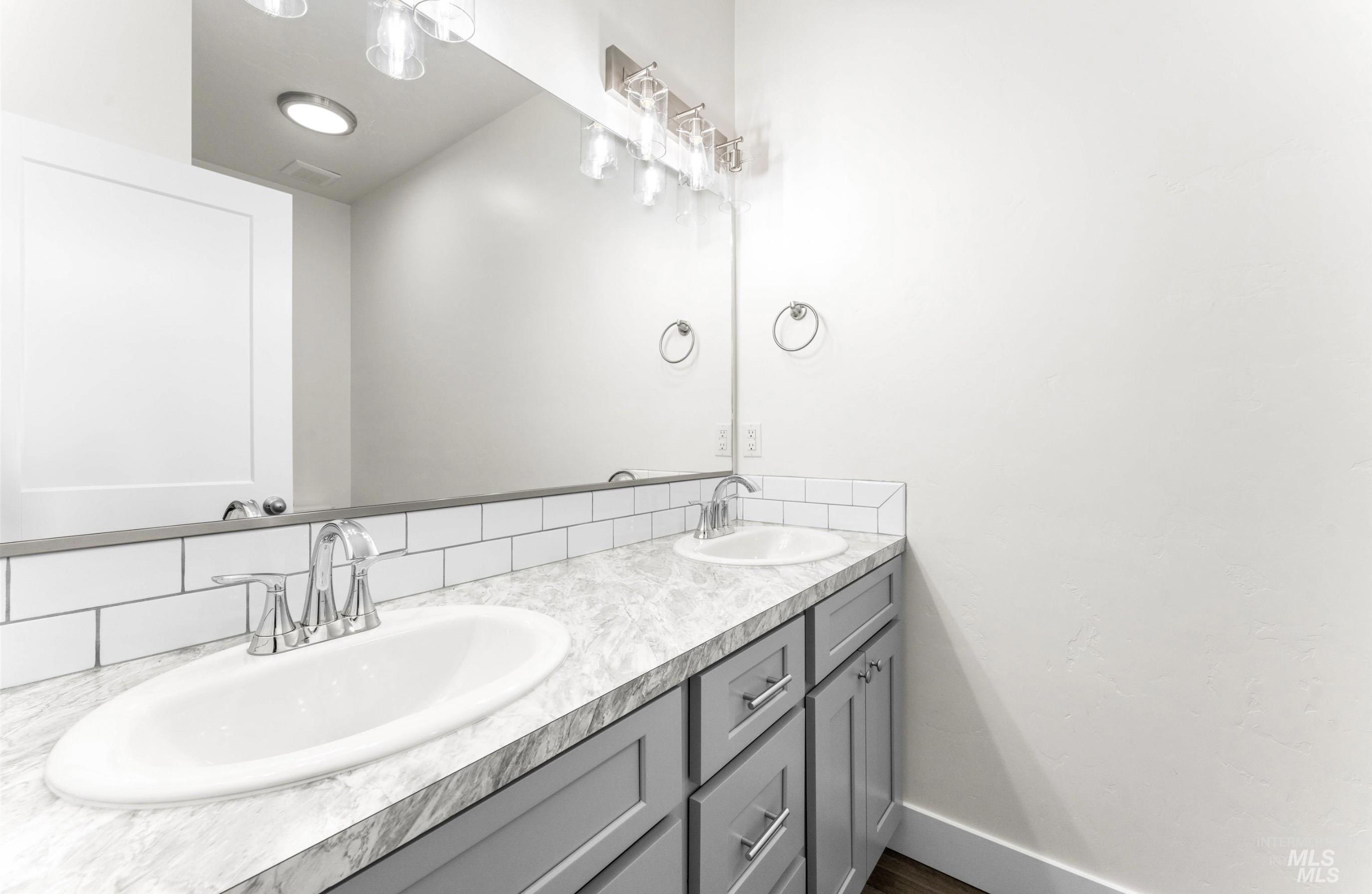 1771 Regency Way Emmett, ID 83617 - Photo 6 of 9 Full bathroom with double vanity and baseboards
