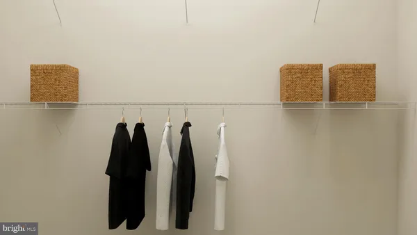 a view of walk in closet with clothes