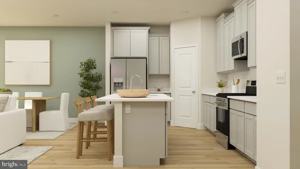 a kitchen with stainless steel appliances a sink a stove a refrigerator cabinets and a dining table