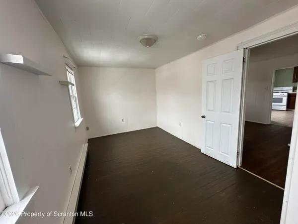 an empty room with wooden floor