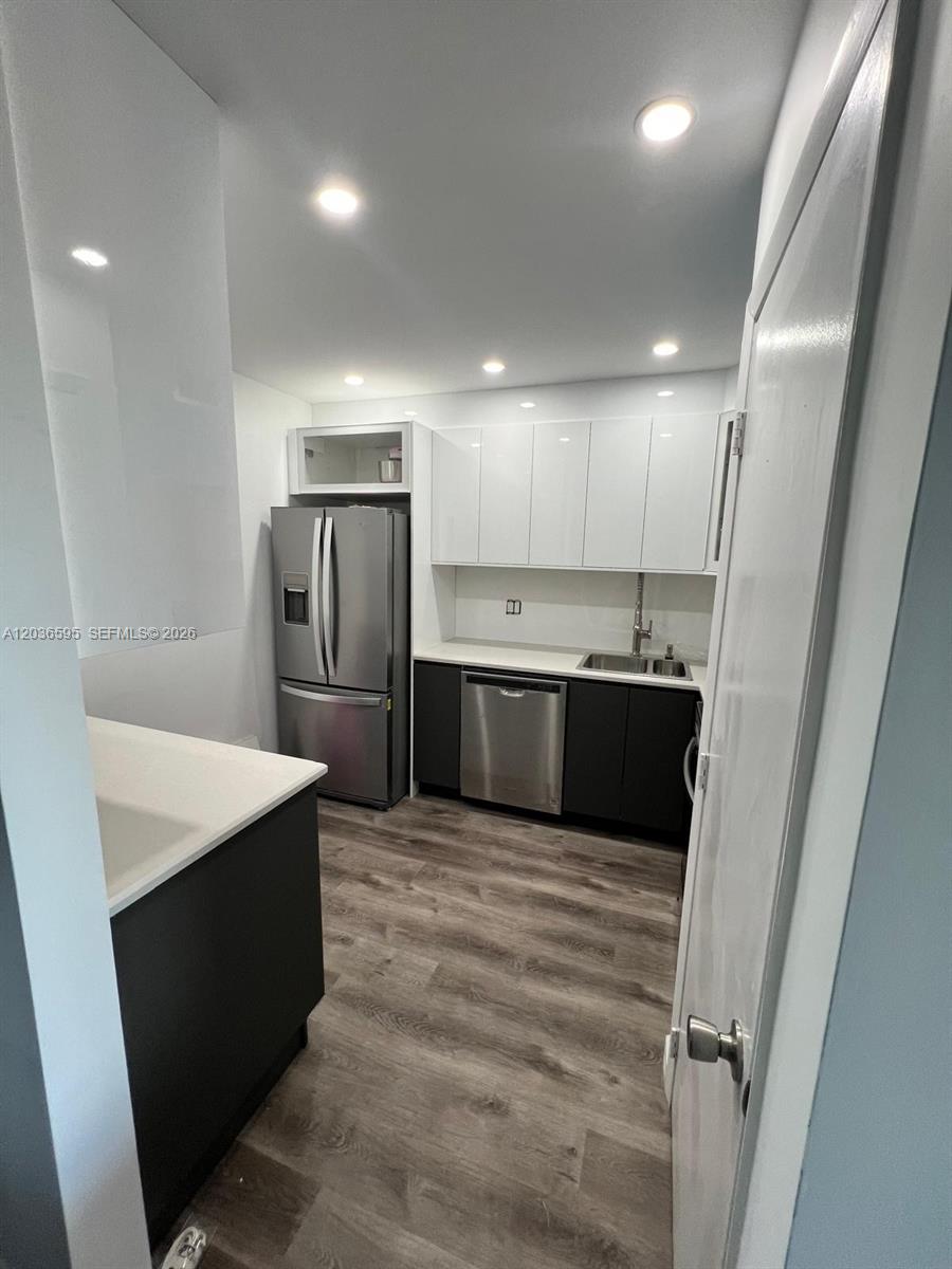 4164 Inverrary Drive, Unit 1004 Lauderhill, FL 33319 - Photo 5 of 15 a large kitchen with a sink and refrigerator