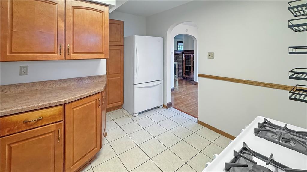 1601 Aurelius Avenue Pittsburgh, PA 15218 - Photo 14 of 30 a kitchen with a refrigerator and cabinets