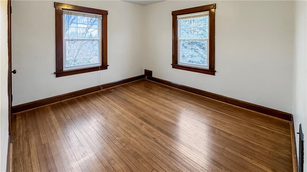 1601 Aurelius Avenue Pittsburgh, PA 15218 - Photo 22 of 30 a view of an empty room with wooden floor and a window