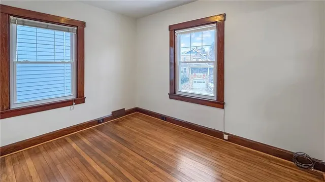 a view of a room with wooden floor and windows