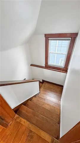 a view of a room with wooden floor and cabinet