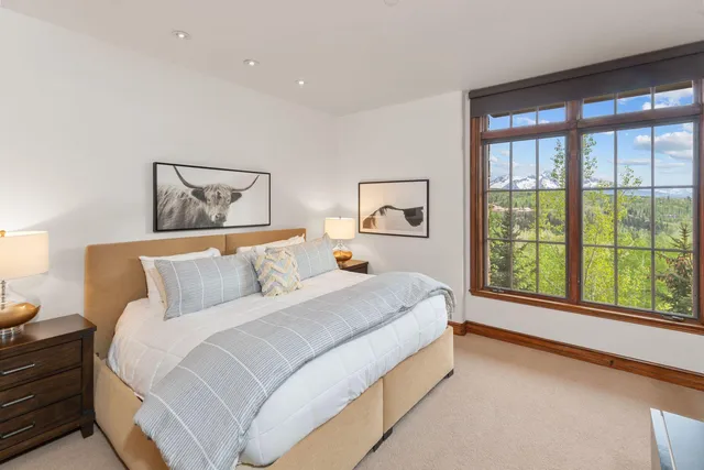 a bedroom with a bed and a lamp