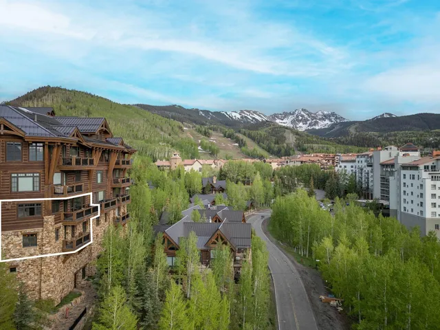 aerial view of a house with a yard and balcony