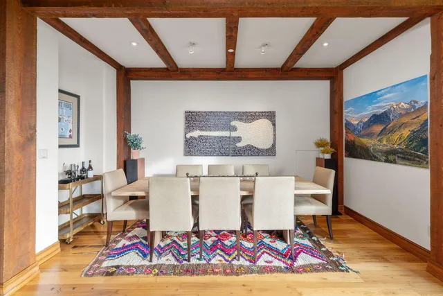a living room with a rug and a table