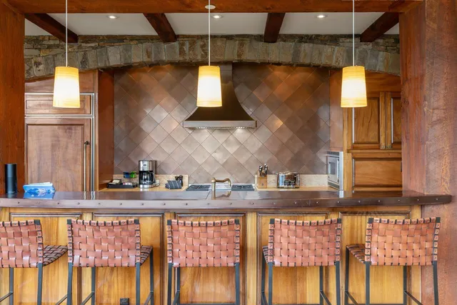 a kitchen with stainless steel appliances granite countertop a sink and a stove