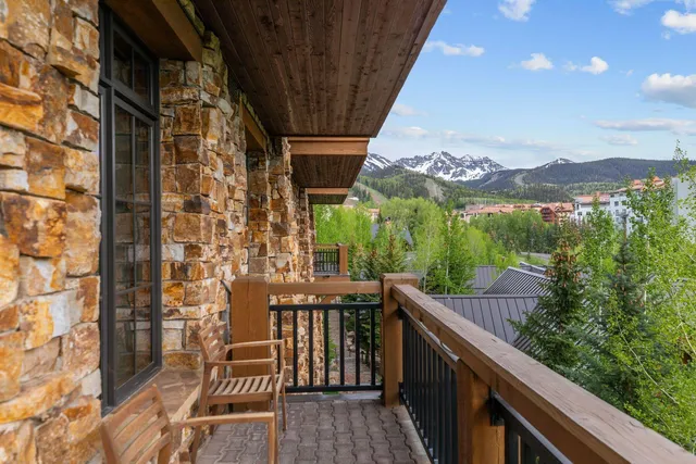 a balcony with wooden floor and city view